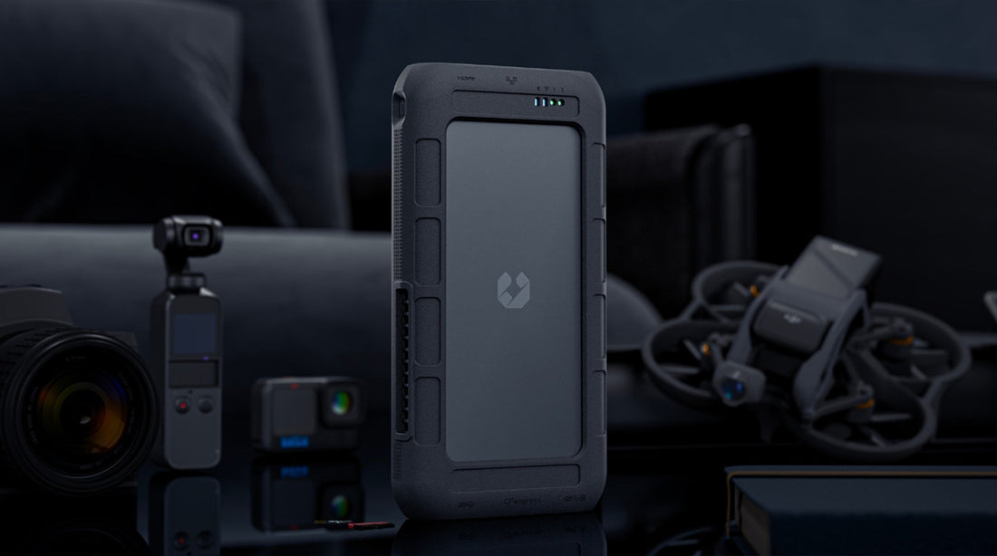 Portable NAS device for photographers and creators, shown with cameras and accessories on a desk
